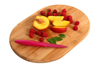 Raspberry and Peach Slices on cutting board