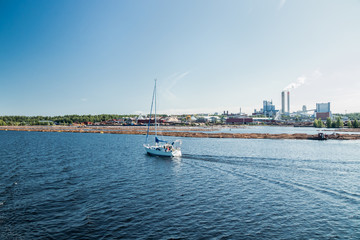 Lappeenranta, Finland - August 7, 2019: Yacht and Upm factory in Lappeenranta, Finland