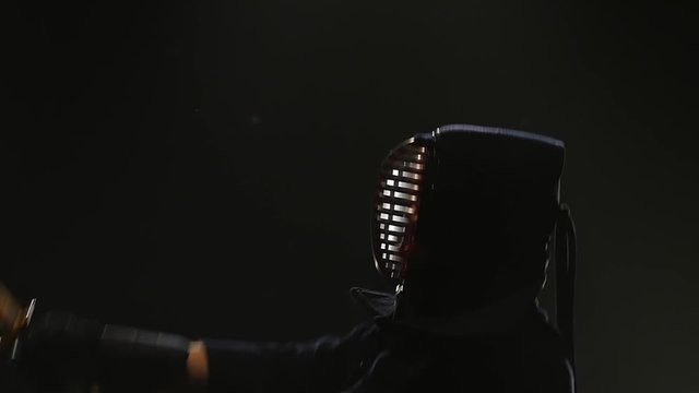 Close-up of Kendo fighter practicing martial art with the Katana sword. Slow motion