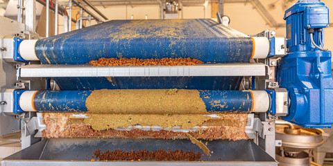 Modern Machine squeezes apples and apple pomace remain as press residues