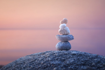 Calming zen rock stack by a lake
