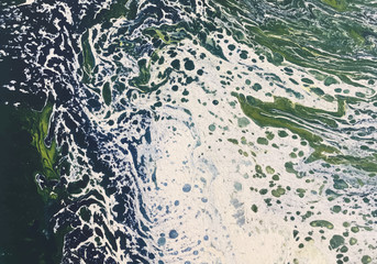 Abstract images from acrylic paint splashed onto canvas background images.