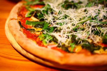 Close-up. Vegetarian pizza on a dark background with mushrooms, cheese and  olive, cutting.