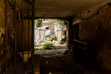Fototapeta na wymiar Picture for decoration of a vintage retro interior. Odessa. An old authentic courtyard with an arch and dried clothes on the ropes. Dry freshly washed clean laundry outdoors