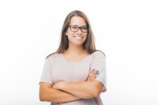 Photo of young woman wearing glasses, with folded hands and pretty smile, over isolated background