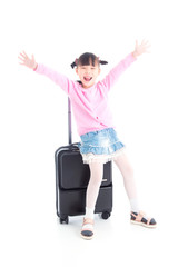 Little asian girl sitting on wheel suitcase and smiles over white background