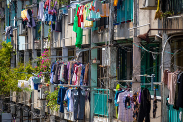 Colorful laundry hanging to dry at old apartment buildings in  Saigon, Ho Chi Minh City