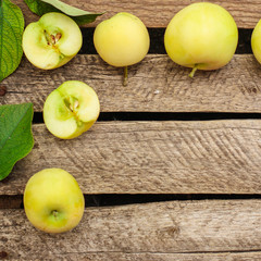 apple, fruits and petals (yellow and green variety of apples, cut into pieces slices). top food background. copy space