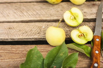 apple, fruits and petals (yellow and green variety of apples, cut into pieces slices). top food background. copy space