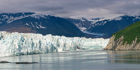 a glacial calf breaks off and splashes into the sea from the face of hubbard glacier in disenchantment bay in alaska