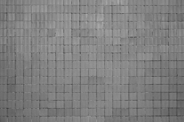 Coole grunge Textur einer grauen Mauer mit quadratischen Steinen