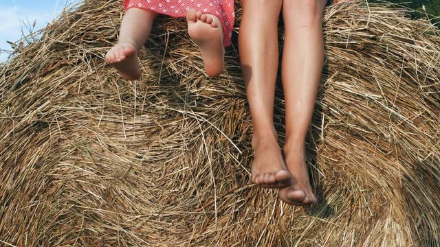 Female and kid feet dangling