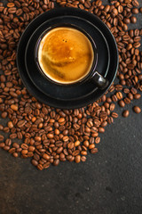 coffee drink in white cup and sprinkle coffee beans on the table. food background. top. copy space