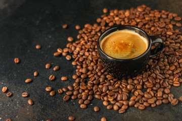 coffee drink in white cup and sprinkle coffee beans on the table. food background. top. copy space