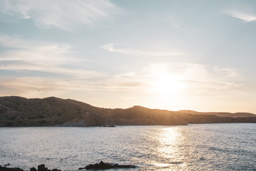 Beautiful sunset and calm seas on a beach.