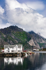 Fototapeta na wymiar Henningsvær harbor, mountains and reflections