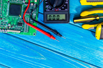 Services for the production of electronics and repair on a wooden blue background.