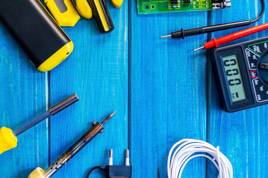 Services for the production of electronics and repair on a wooden blue background.