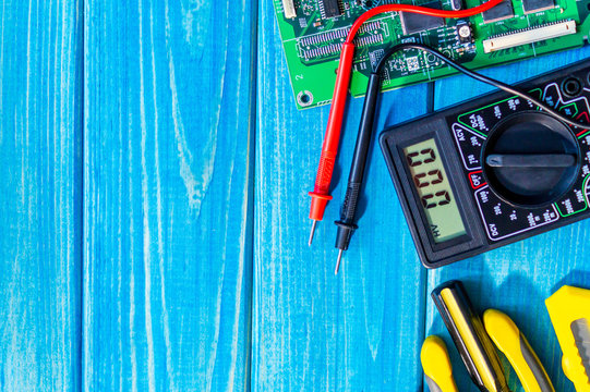Services for the production of electronics and repair on a wooden blue background.