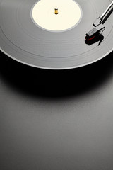 Black vinyl record player on black table background