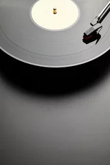 Tuinposter Black vinyl record player on black table background © digieye