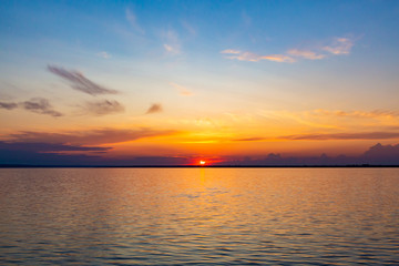 Fototapeta premium Sunset on the Volga river in Russia in July. Orange sun in the sky. Picturesque nature. Summer evening. River cruise