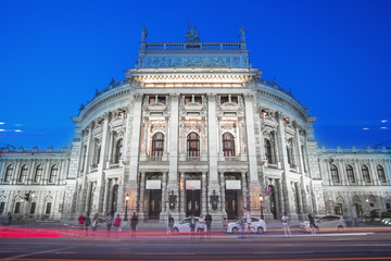 Fototapeta na wymiar Vienna Opera house during the night moving with light trails and street light in Austria