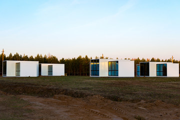Fototapeta na wymiar One-storey modular houses with large panoramic Windows. Russia. House of sandwich panels