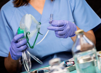 Nurse prepares oxygen mask in hospital, conceptual image