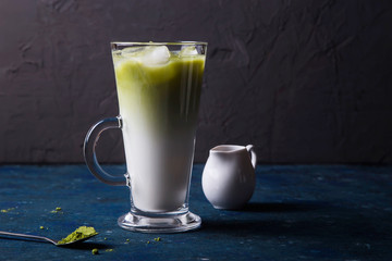 Green matcha powder milk and ice tea summer drink
