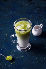 Green matcha powder milk and ice tea summer drink