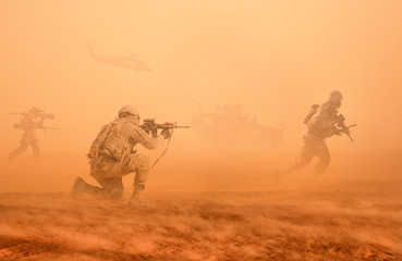 Military troops and machines on the way to the battlefield in desert.