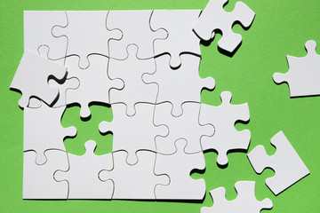 Close-up of puzzle piece on green background
