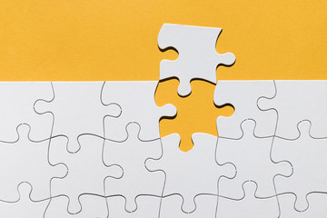 White jigsaw puzzle texture on yellow background