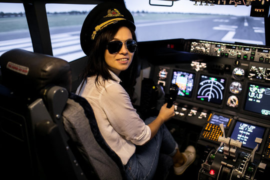 Female pilot the captain of the plane prepares for take-off in the plane cockpit.