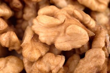 Walnut abstract background texture, copy space. Pieces of chopped walnuts. Top view, flat lay, overhead shot
