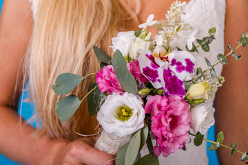 Bridal bouquet on the wedding day. Flowers for the bride. Small wedding bouquet close-up.