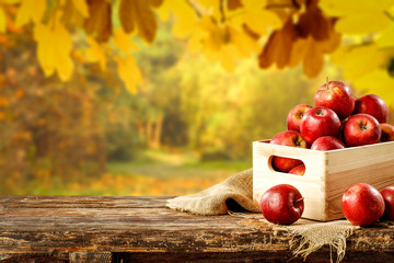 Fresh red apples in wooden box and free space for your decoration 