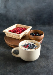 Granola with wild berries, lingonberries and blueberries. Mug breakfast.