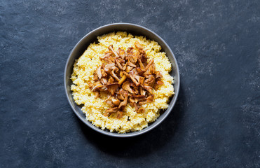 Polenta with chanterelles on a black background.