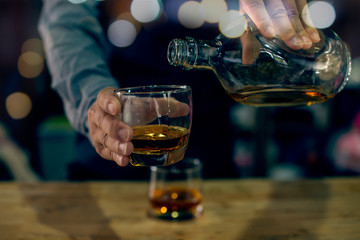 glass of whiskey on wooden table