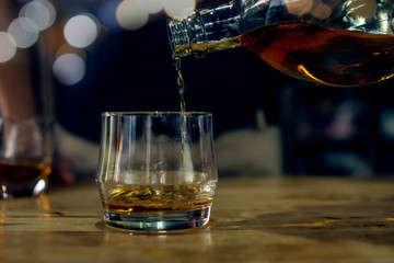 glass of whiskey and ice on table