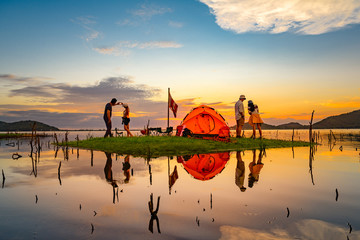 couple lovers tourist camping are enjoy together, cheerfully on the small island in the lake at...