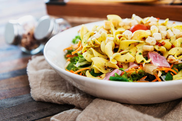 Salad with speck ham and egg, tomatoes