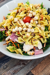 Salad with speck ham and egg, tomatoes