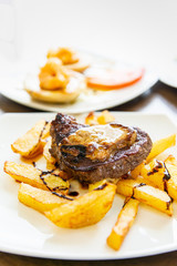 juicy steak beef meat with tomato and french fries