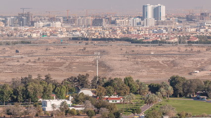 Obraz premium Aerial view to villas and houses with Golf course with green lawn and lakes timelapse