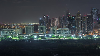 Jumeirah lake towers skyscrapers and golf course night timelapse, Dubai, United Arab Emirates