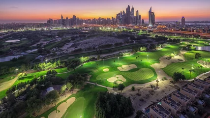 Rolgordijnen Dubai Marina skyscrapers and golf course day to night timelapse, Dubai, United Arab Emirates © neiezhmakov