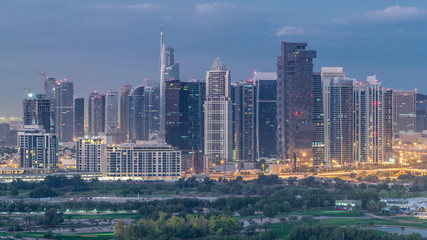 Jumeirah lake towers skyscrapers and golf course night to day timelapse, Dubai, United Arab Emirates